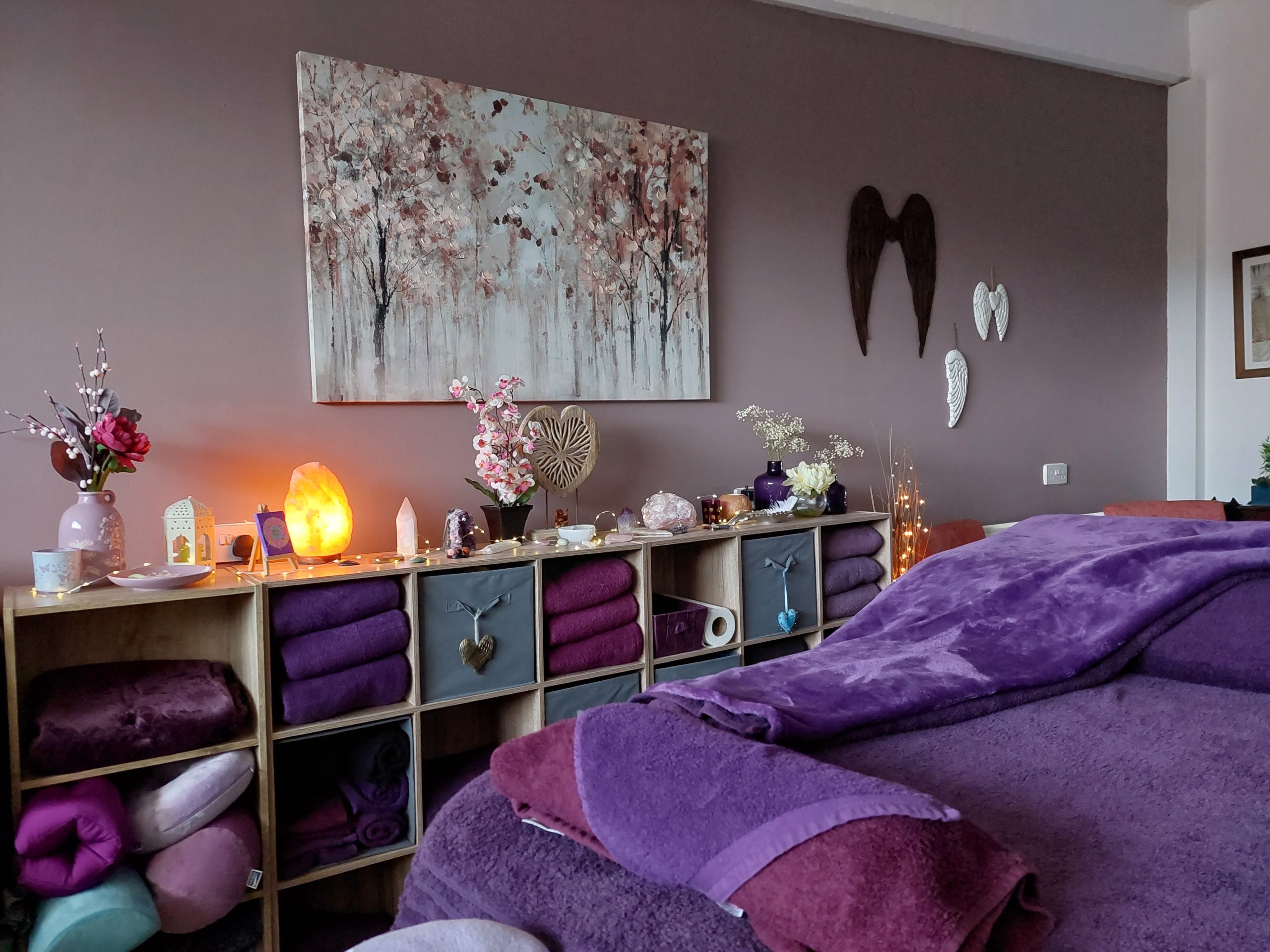 This is a picture of the treatment bed at Libra Light Holistic Therapies in Falkirk. The colour scheme is in relaxing purple tones.