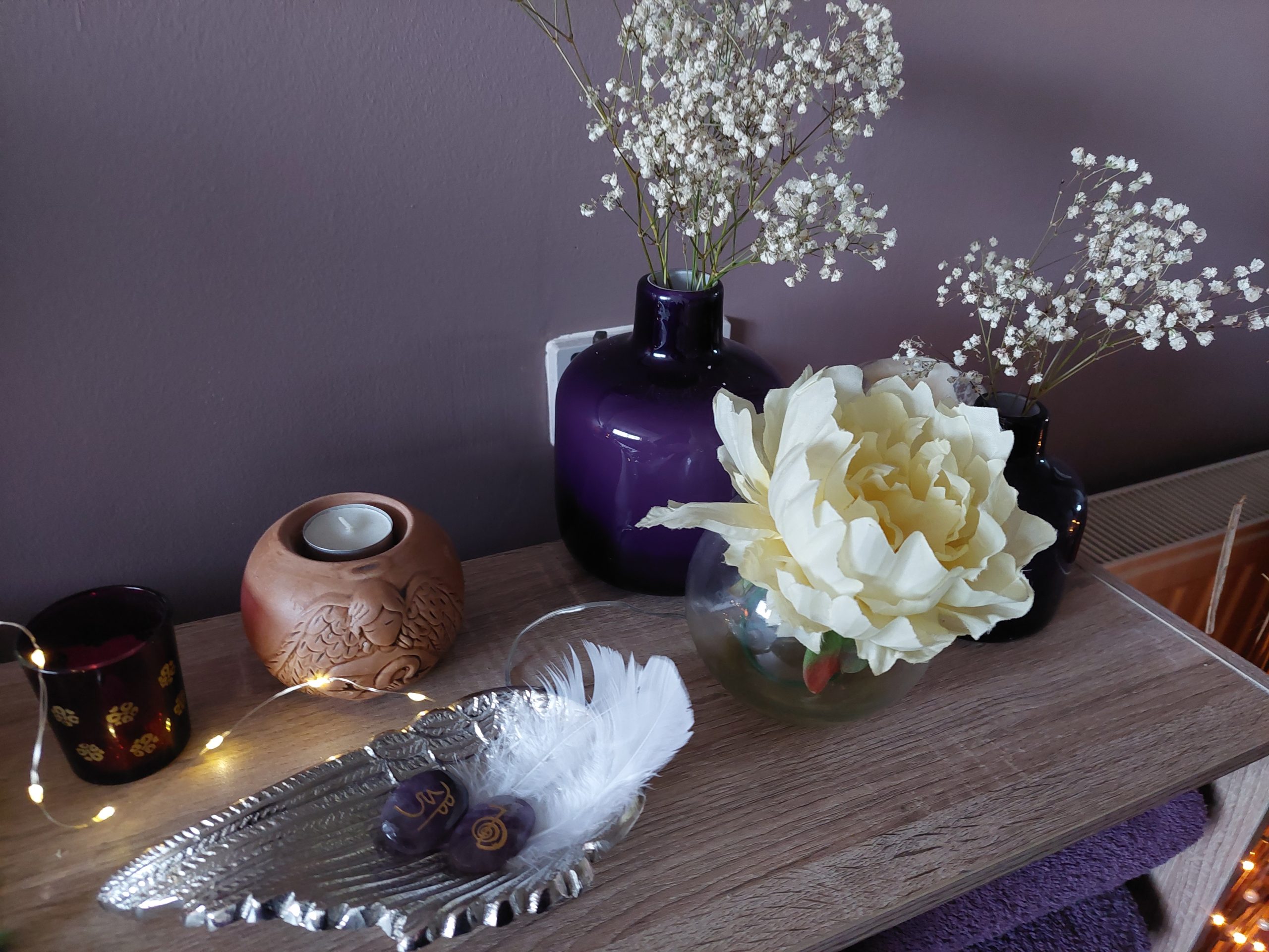 This is a picture of Libra Light Holistic Therapies massage therapy room, in Falkirk, showing angel wings, flowers and feathers